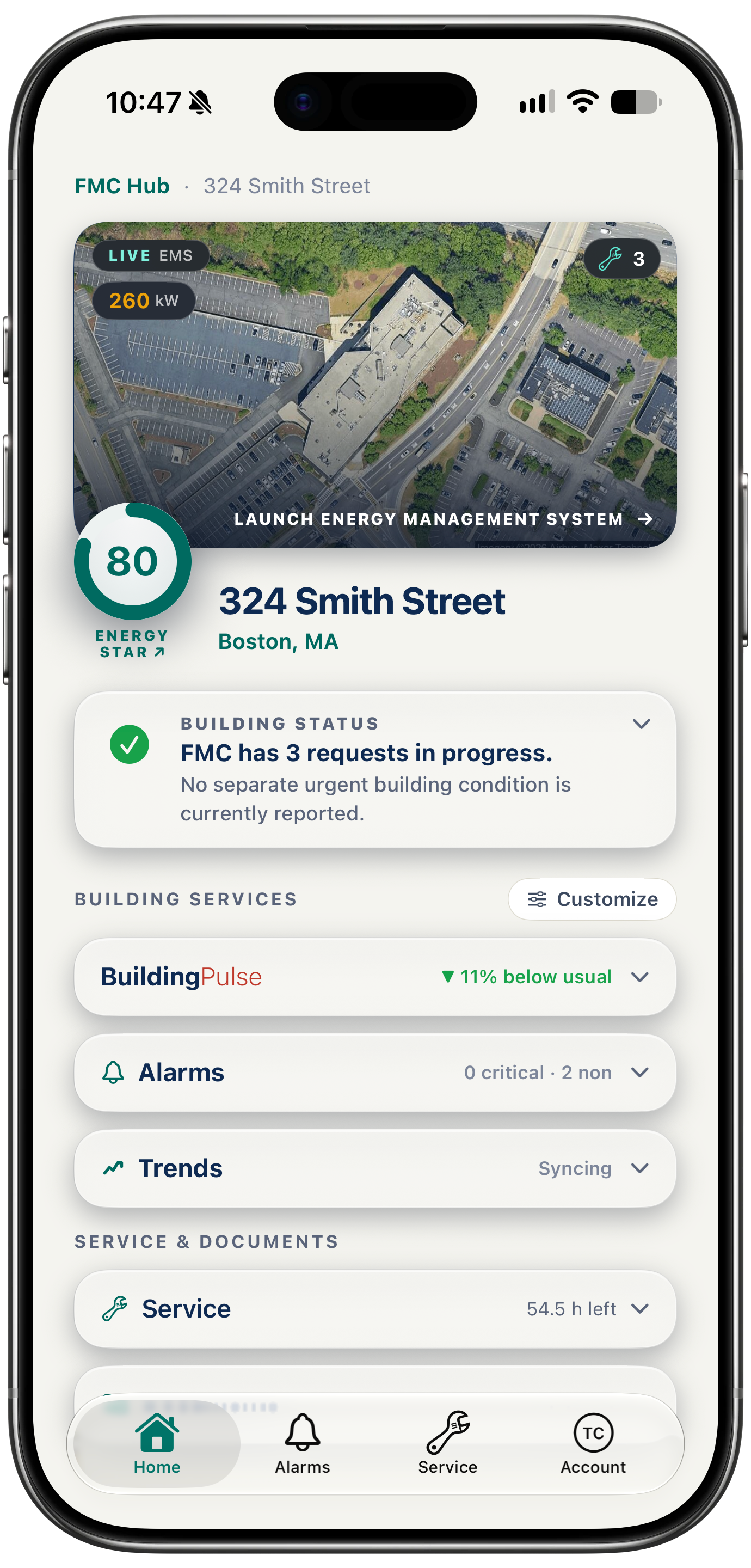A single location page in the FMC Customer Hub on an iPhone: the building from above, its status, and links to its energy management system, BuildingPulse, alarms, trends, service and documents